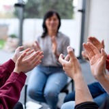 Men And Women Sitting In Circle During Group Therapy